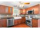Kitchen with cherry cabinets, stainless steel appliances and a farmhouse sink at 105 Kirkland Ct, Archer Lodge, NC 27527