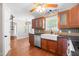 Well-lit kitchen features cherry cabinets, stainless steel appliances, and a farmhouse sink at 105 Kirkland Ct, Archer Lodge, NC 27527