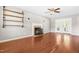 This living room features wood floors, ceiling fan, a fireplace, and built-in shelves at 105 Kirkland Ct, Archer Lodge, NC 27527
