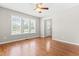 This living room features wood floors, ceiling fan and three windows at 105 Kirkland Ct, Archer Lodge, NC 27527