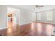 This living room features wood floors, ceiling fan and leads to kitchen at 105 Kirkland Ct, Archer Lodge, NC 27527