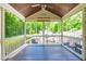 A screened-in porch with seating and views of the wooded backyard at 105 Kirkland Ct, Archer Lodge, NC 27527