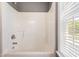 The bathroom has a shower with sleek fixtures and a large window that provides natural light at 105 Kirkland Ct, Archer Lodge, NC 27527