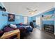 Spacious blue bedroom featuring unique wall decorations, computer desk, and a ceiling fan at 109 Winding Creek Dr, Youngsville, NC 27596