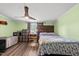 Comfortable bedroom with a queen bed, wood floors, a wood headboard, and neutral decor at 109 Winding Creek Dr, Youngsville, NC 27596