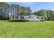 Charming one-story home with a white porch, complimented by a spacious lawn and bordered by trees at 109 Winding Creek Dr, Youngsville, NC 27596