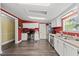 Functional kitchen with stainless steel appliances, white cabinets, and laminate countertops on hardwood floors at 109 Winding Creek Dr, Youngsville, NC 27596