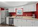 Functional kitchen featuring stainless steel appliances, white cabinets, laminate countertops, and hardwood floors at 109 Winding Creek Dr, Youngsville, NC 27596