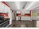 Bright kitchen featuring stainless steel appliances, white cabinets, laminate countertops, and hardwood floors at 109 Winding Creek Dr, Youngsville, NC 27596