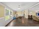 Spacious living room featuring hardwood floors, wainscoting, a window, and ample natural light at 109 Winding Creek Dr, Youngsville, NC 27596