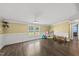 Spacious living room featuring hardwood floors, wainscoting, a window, and ample natural light at 109 Winding Creek Dr, Youngsville, NC 27596
