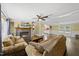Inviting living room features a stone fireplace, ceiling fan, and comfortable seating area, with hardwood floors at 109 Winding Creek Dr, Youngsville, NC 27596