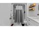 Bright bathroom with white vanity, tub/shower, and stylish fixtures at 11 Stone Village, Durham, NC 27704
