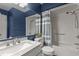 Stylish bathroom with blue walls, a marble vanity, and a shower-tub combo at 11 Stone Village, Durham, NC 27704