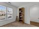 Well-lit bedroom with a large window view and a modern bookcase at 11 Stone Village, Durham, NC 27704