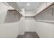 Walk-in closet with ample shelving and storage space for organization at 11 Stone Village, Durham, NC 27704