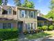 Charming two-story townhome with tan siding, gray shutters, and manicured front yard at 11 Stone Village, Durham, NC 27704