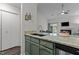 Open kitchen featuring green cabinets, stainless steel appliances, and granite counters at 11 Stone Village, Durham, NC 27704
