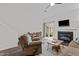 Open-concept living room showcasing a fireplace, wood floors, and seamless access to the backyard at 11 Stone Village, Durham, NC 27704