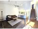 Spacious living area featuring wood floors, a cozy sofa, and seamless access to the kitchen at 11 Stone Village, Durham, NC 27704