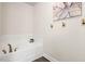 Bright bathroom featuring a modern tub with stylish fixtures and decorative wall art at 11 Woodwater Cir, Lillington, NC 27546