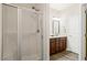 Modern bathroom with glass enclosed shower, wooden cabinets and tile flooring at 11 Woodwater Cir, Lillington, NC 27546