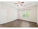 Spacious primary bedroom featuring tray ceiling, ceiling fan, and natural light at 11 Woodwater Cir, Lillington, NC 27546