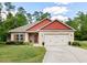 Charming brick home with red accents, manicured lawn and a two-car garage at 11 Woodwater Cir, Lillington, NC 27546