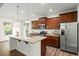 Modern kitchen with granite countertops, stainless steel appliances, and island at 11 Woodwater Cir, Lillington, NC 27546