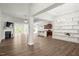 Open-concept living area with fireplace, hardwood floors, and view of kitchen and dining at 11 Woodwater Cir, Lillington, NC 27546