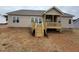 New deck with stairs leading to a yard, perfect for outdoor enjoyment at 112 Royal Ave, Selma, NC 27576