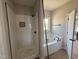 Bathroom featuring a tiled shower, a soaking tub and elegant fixtures. Perfect for spa days at home at 112 Royal Ave, Selma, NC 27576