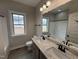 A bathroom with granite countertops, dual sinks, and a tub-shower combination at 112 Royal Ave, Selma, NC 27576