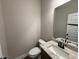 Bathroom with a stylish granite countertop and a sink with modern faucet at 112 Royal Ave, Selma, NC 27576