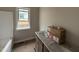Bathroom features a granite countertop, dual sink vanity, window for natural light, and a bathtub with tile surround at 112 Royal Ave, Selma, NC 27576