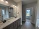 A modern bathroom with granite countertops, dual sinks, and a tub-shower combination at 112 Royal Ave, Selma, NC 27576
