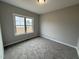 Cozy bedroom with a neutral carpet and a window that allows plenty of natural light at 112 Royal Ave, Selma, NC 27576
