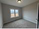 Neutral bedroom offers natural light from the large window and carpet flooring at 112 Royal Ave, Selma, NC 27576