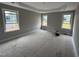 Bright bedroom with three windows and tray ceiling offering ample natural light at 112 Royal Ave, Selma, NC 27576