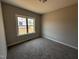 Neutral bedroom featuring plush carpeting and a bright window offering natural light at 112 Royal Ave, Selma, NC 27576