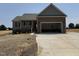 Charming single-story home featuring a two-car garage and covered front porch, all nestled on a spacious lot at 112 Royal Ave, Selma, NC 27576