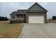 Charming home featuring a two-car garage, covered porch, and well-maintained lawn at 112 Royal Ave, Selma, NC 27576