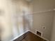 A practical laundry room is equipped with hookups and shelving for organized convenience in home chores at 112 Royal Ave, Selma, NC 27576