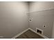 A small laundry area with gray walls and wood look floors, and a wire shelf at 112 Royal Ave, Selma, NC 27576