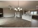 A view of the open-concept living space, featuring a fireplace and views to the kitchen at 112 Royal Ave, Selma, NC 27576