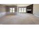 Inviting living room with a stone fireplace and bright windows, perfect for entertaining guests at 112 Royal Ave, Selma, NC 27576