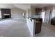 Open-concept living space connecting the kitchen to the living room with a stone fireplace at 112 Royal Ave, Selma, NC 27576