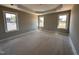 Bright main bedroom with large windows and a tray ceiling, creating a peaceful retreat at 112 Royal Ave, Selma, NC 27576
