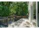 Open back deck space with black metal railing, stairs down to back yard and a wood fence at 1124 Upchurch St, Raleigh, NC 27610