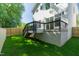 Expansive deck accessible from the backyard with stairs down to the spacious lawn surrounded by a wood fence at 1124 Upchurch St, Raleigh, NC 27610